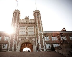 looking up the steps at Brookings Hall with the sun shining around the edge of the tower